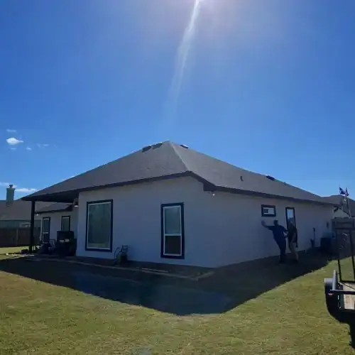 Single‑story home with architectural shingles under bright sky, illustrating residential roofing warranty protection by Dolan Roofing & Construction in San Antonio