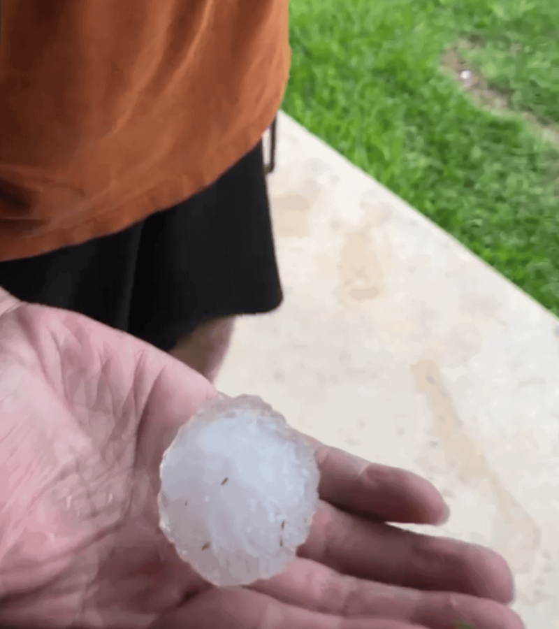 San Antonio resident holding hail after storm damage event