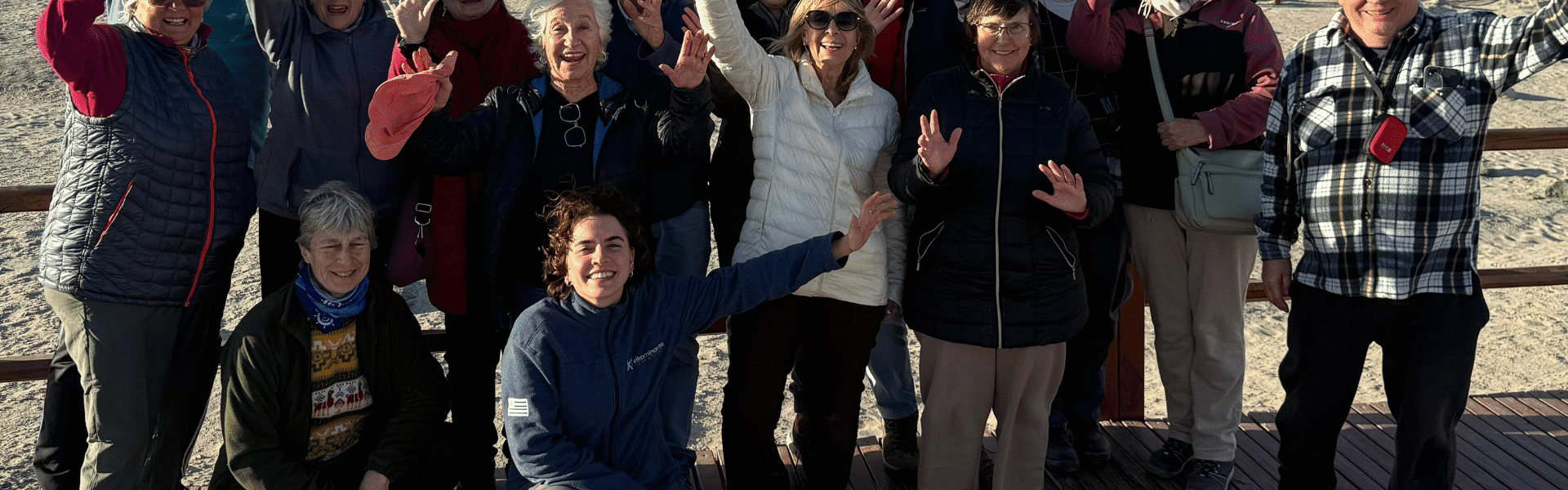 Enjoying a group outing outdoors on a wooden deck with scenic rocky background and clear skies.