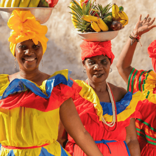 Vendedoras con trajes tradicionales coloridos en una celebración cultural en Uruguay.