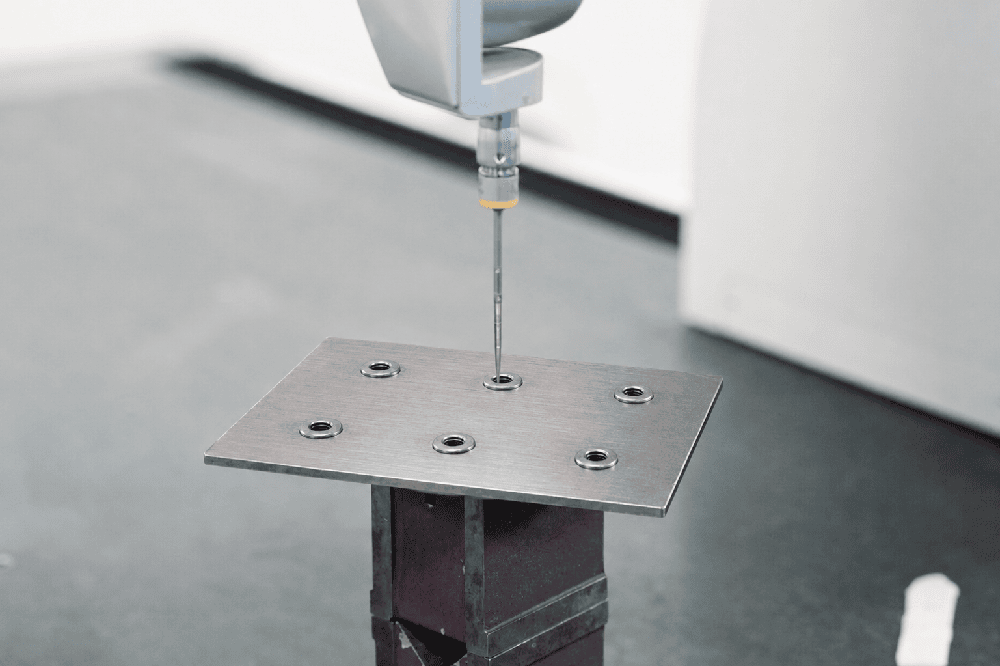 CMM probe measuring rivet nut position on SPHC sheet metal plate first article inspection