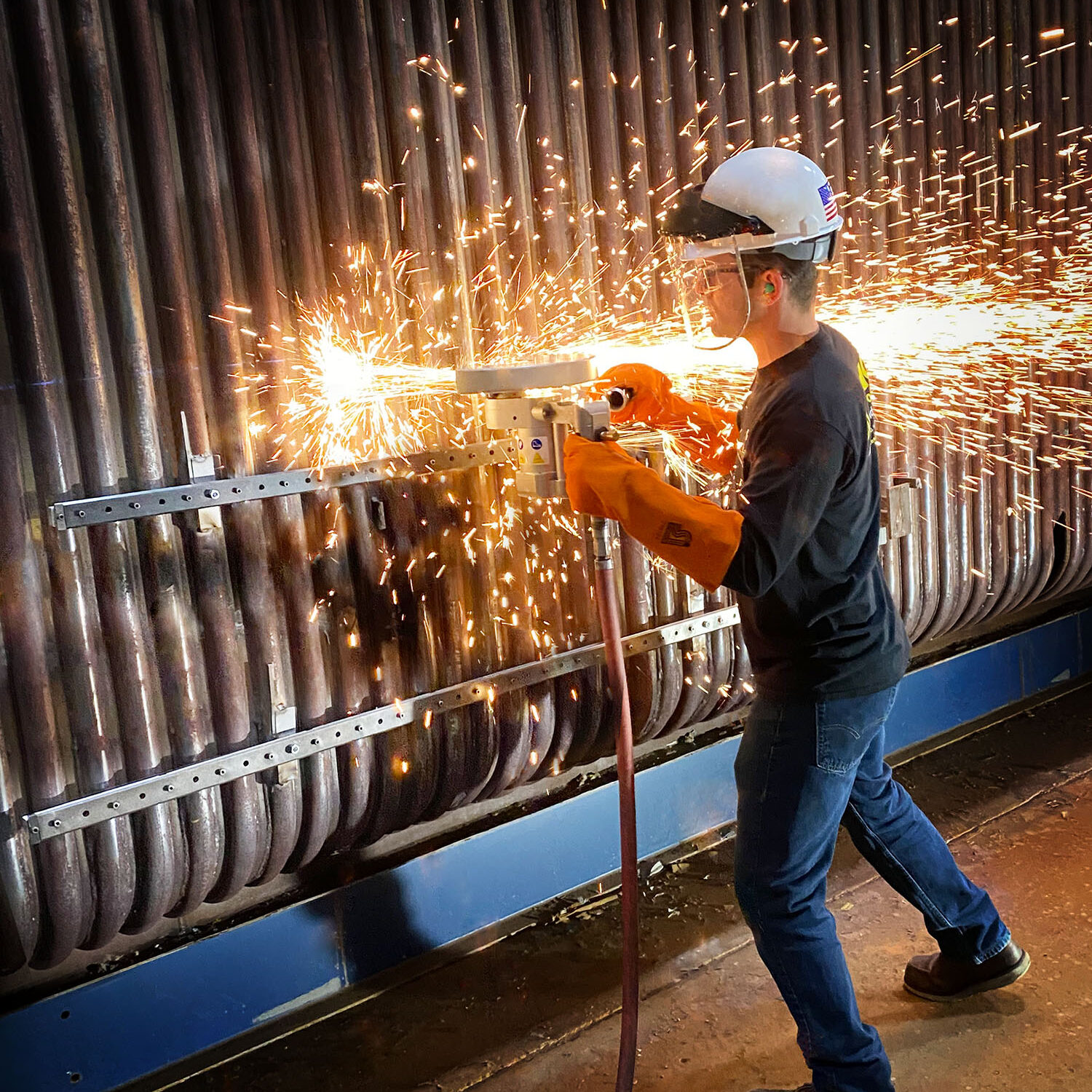 High-capacity MILLHOG portable tube end prep tool working on boiler pipes, featuring model-specific design and gas market mounting.