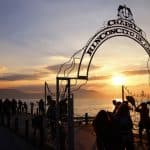 Farr Law Firm image with people enjoying a sunset at a historic pier, highlighting legal services and community engagement.