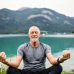 A senior man meditating.