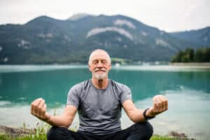A senior man meditating.