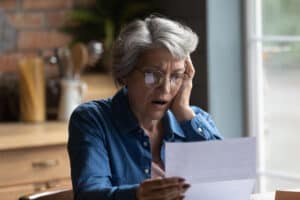 woman looking at hospital bills