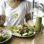 Fresh salad and smoothies on a wooden table, promoting healthy eating habits and nutritious food options. Ideal for wellness, diet-conscious individuals, and balanced meal choices.