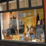 Harry Potter themed window display for Farr Law Firm, featuring books and decorations, showcasing the firm's community involvement and support for local events.