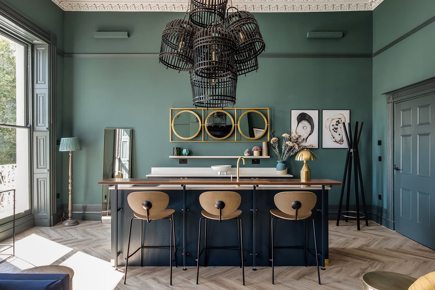 Elegant green walls with stylish decor and lighting fixtures.