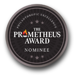 A circular black and grey badge with the text "Philanthropic Excellence, The Prometheus Award, Nominee" and a small flame graphic.