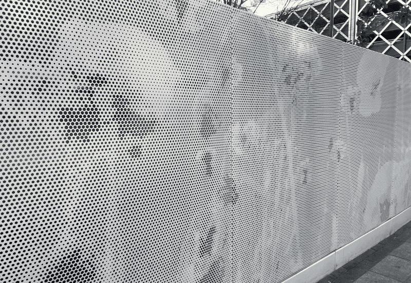 Close up of a service enclosure manufactured in perforated metal images of poppy flower