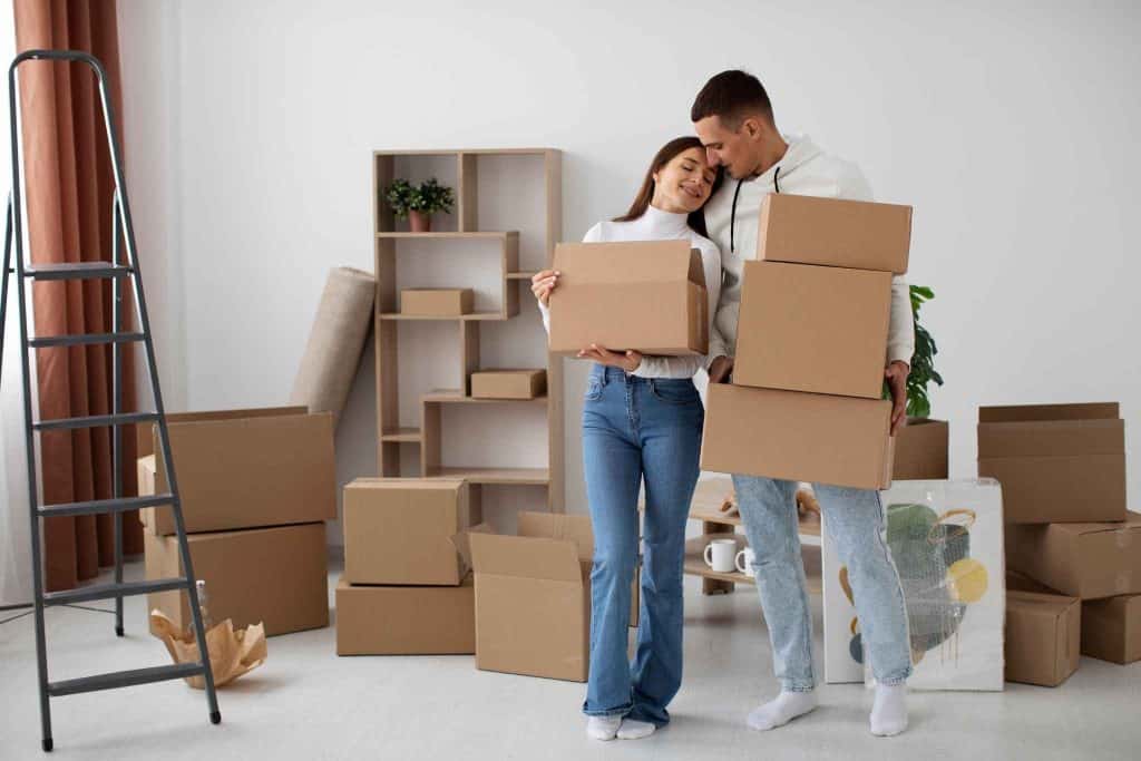 Moving boxes and happy couple during a move in a modern home.