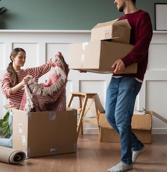 Family packing boxes for moving with Green Apple Movers in a home.
