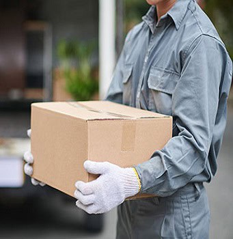 Professional mover holding a cardboard box for local moving services in Toronto.