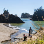 Man and dog taking in the view of Secret Beach.