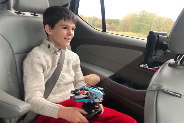 Playing Nintendo Switch in the car on a road trip.