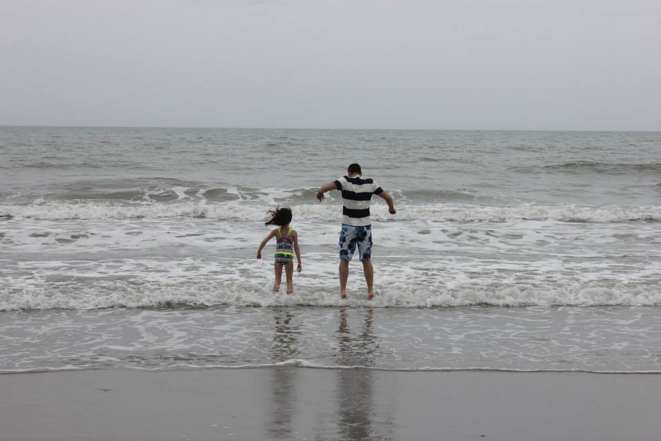 Cheap Spring Break Trips For Families In The U.S. People playing in the ocean at Myrtle Beach.