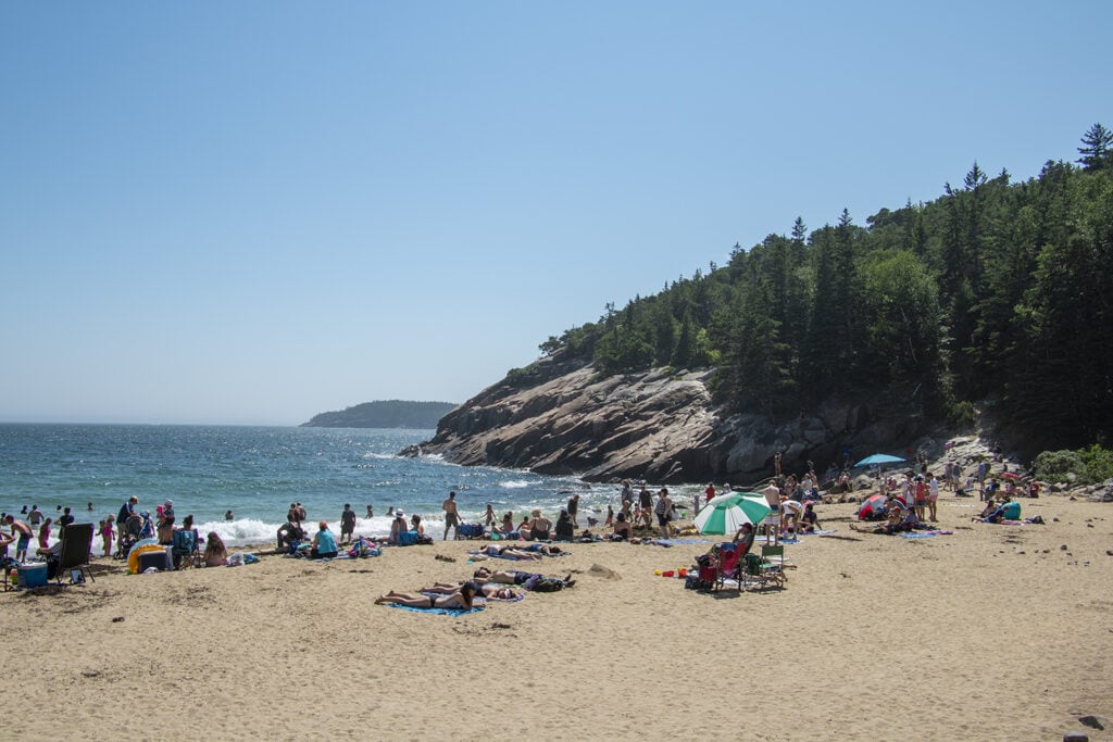 Best Hikes in Acadia National Park + Tips People enjoying Sand Beach in Acadia