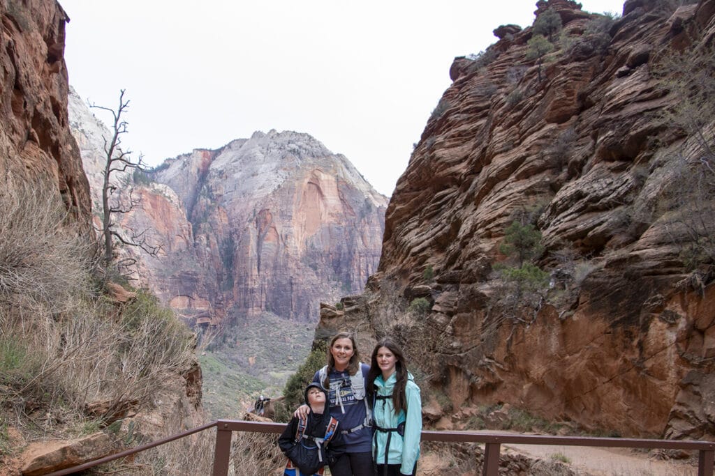 What to Pack for Zion National Park: A family-friendly Guide Family enjoying a breathtaking view of Zion National Park's iconic red rock formations and expansive landscapes