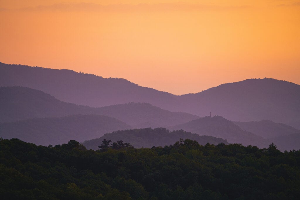 Discover the Funnest National Parks for Kids Orange sunset view of the Great Smoky Mountains ranges.