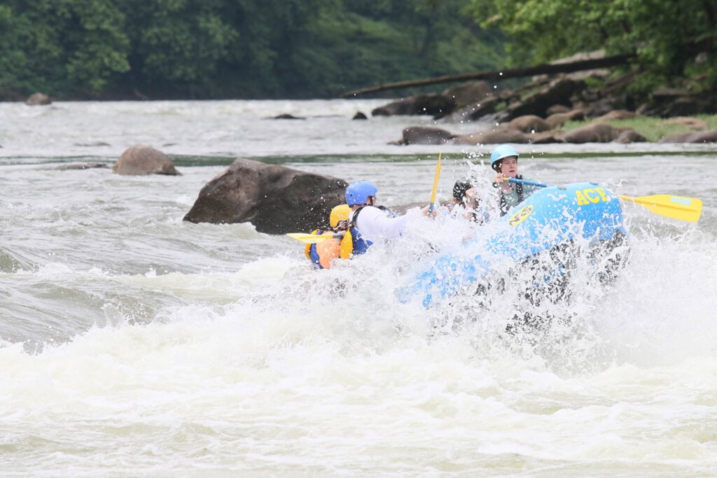 New River Gorge Whitewater Rafting With Ace Adventure Action shot of family whitewater rafting in New River Gorge, West Virginia