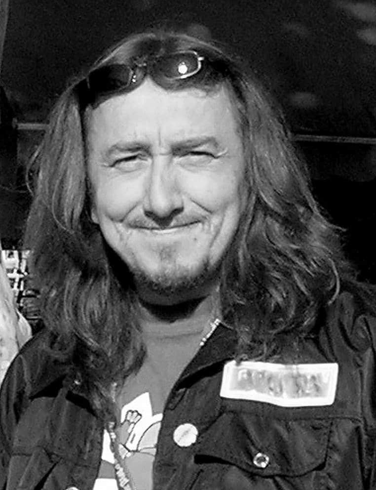Supporter smiling at Hero Initiative event, advocating for artist financial assistance.