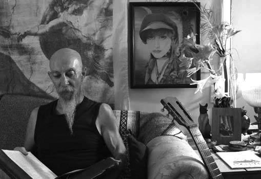 Senior man reading in cozy living room with artistic decor and guitar.