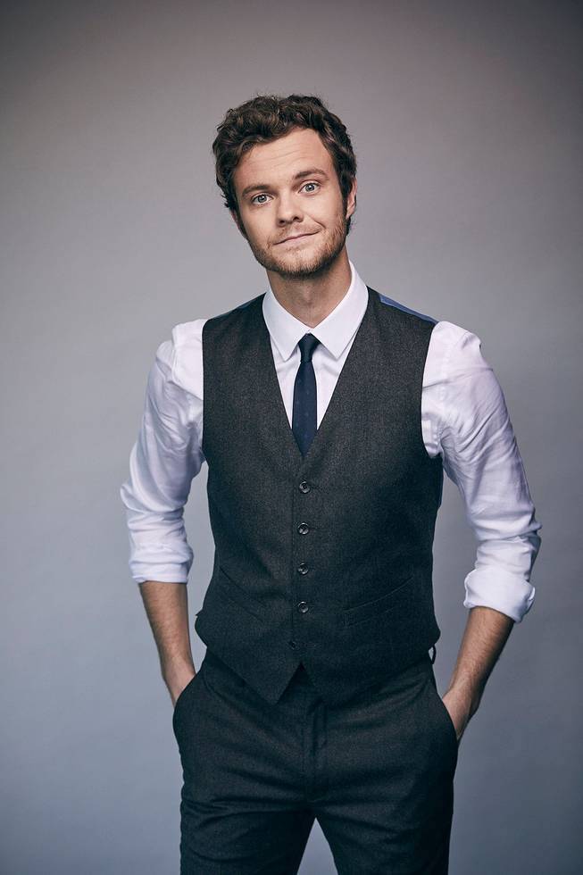 A confident man in a formal vest and tie, symbolizing support for Hero Initiative and artist causes.