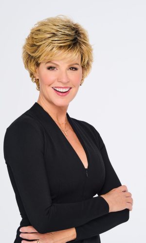 Short swept back hairstyle on mature woman with blonde hair.