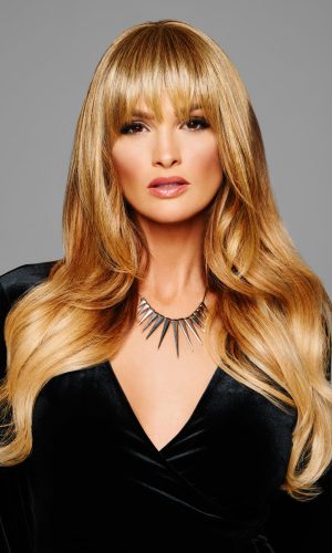 Woman with long, layered blonde fringe wig for trendy hairstyle.