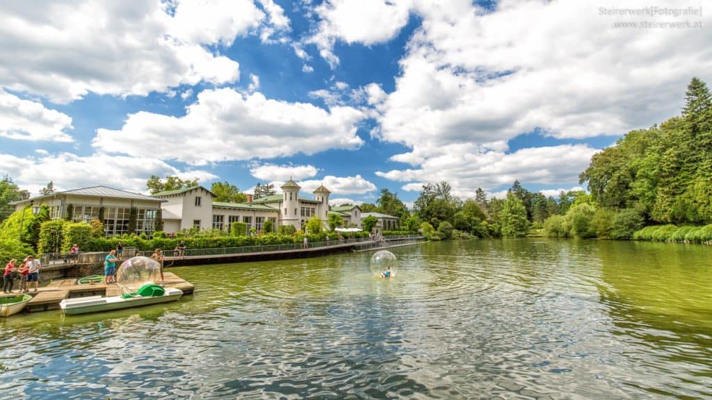 A building in front of a pond