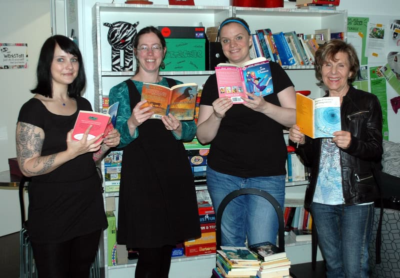Four women holding books