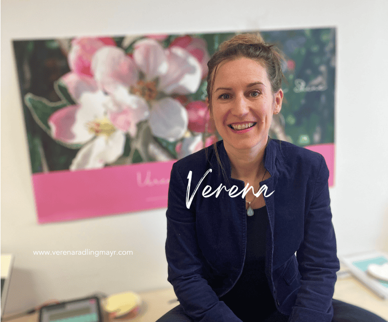 A woman with a picture of flowers behind her
