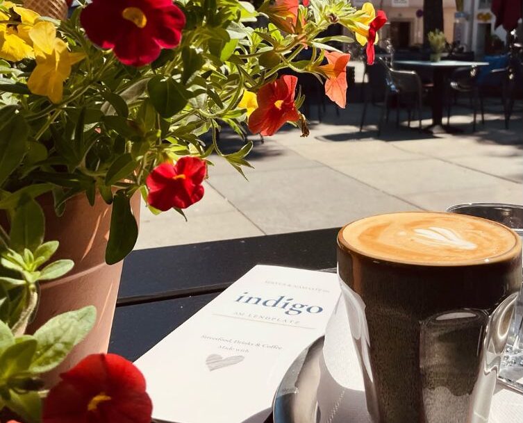 Flowers and a chai and a menu at a stand