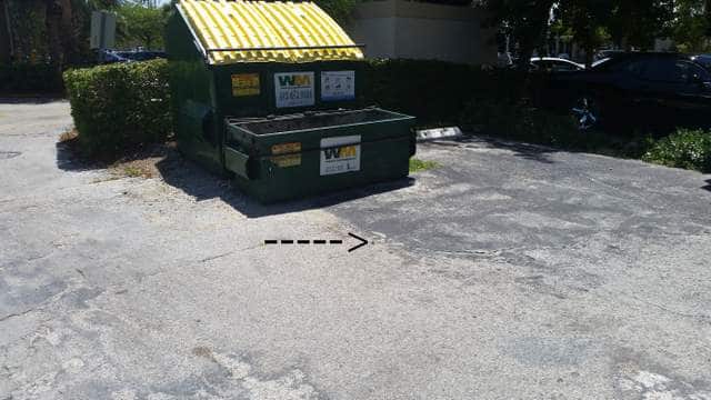 rod sticking out of the ground in office building parking lot