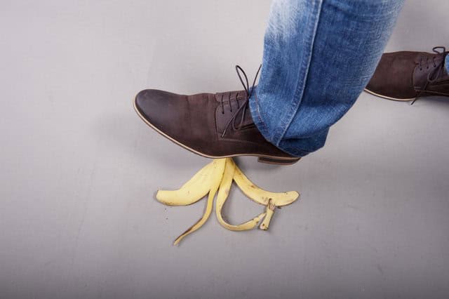 Man stepping on banana peel