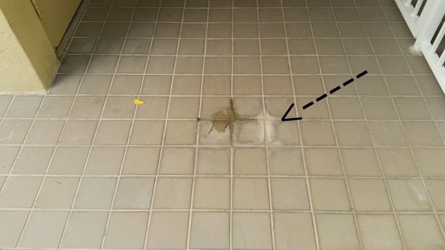 Stain from water dripping from exit sign onto exterior flooring