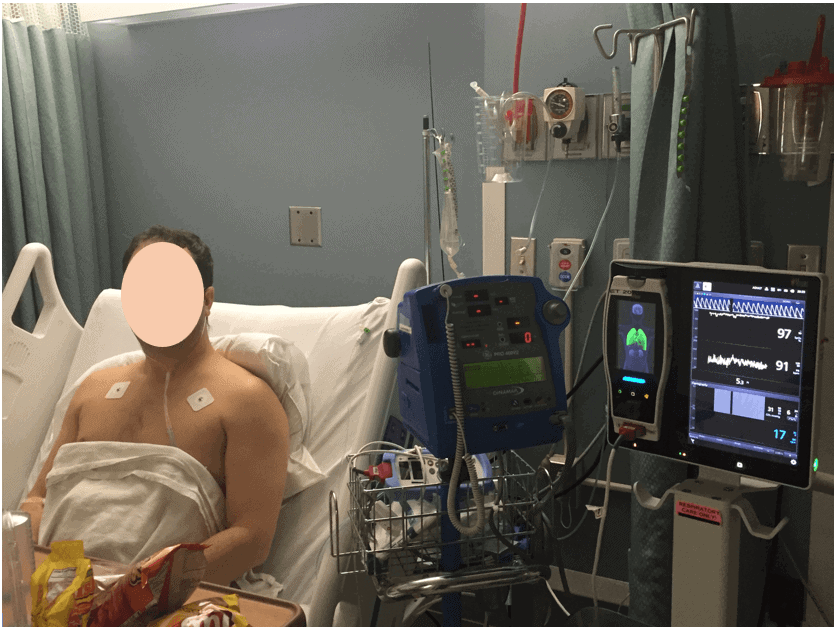 patient in hospital bed with leads on his chest