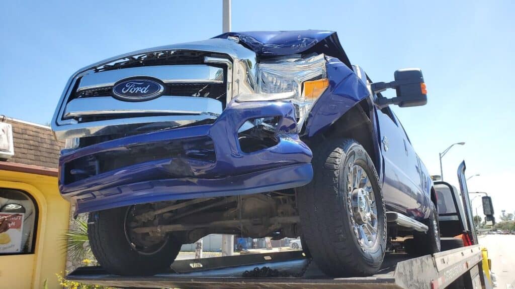 front damage to pickup truck frame, fender and hood are damaged; front driver side also is damaged.
