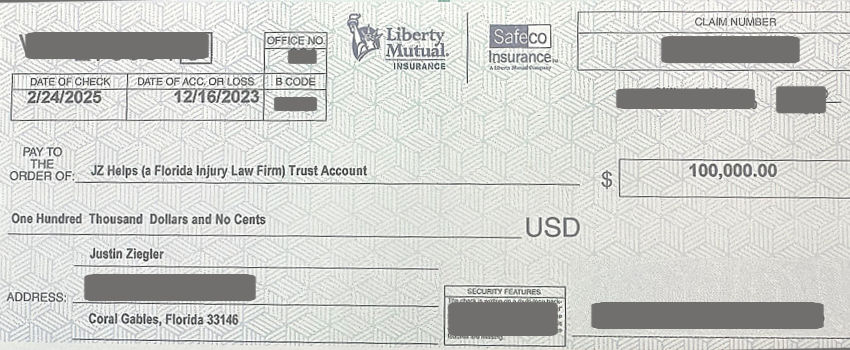 A redacted Liberty Mutual insurance settlement check for $100,000 made payable to JZ Helps (a Florida Injury Law Firm) Trust Account. The check is issued for a dog bite injury claim, with sensitive information such as claim number, routing details, and signatures blacked out for privacy.