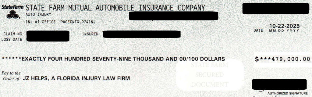 Redacted State Farm settlement check for $479,000 payable to JZ Helps, a Florida injury law firm, from a personal injury case involving surgery and other injuries.