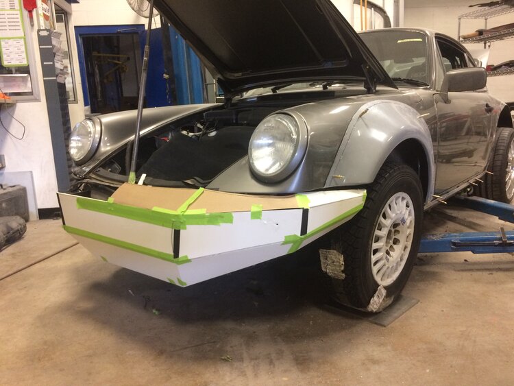 Restoring a 1990 Porsche 964 C4 in a workshop setting.
