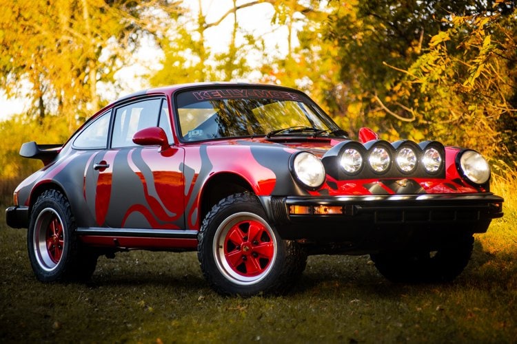 Custom Porsche 911 with rally lights and red accents, vintage style.