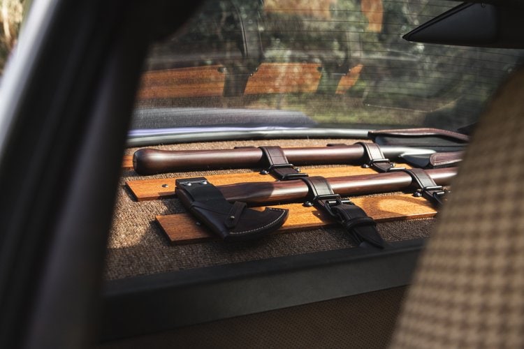 Vintage pistols and holsters stored in a car trunk.