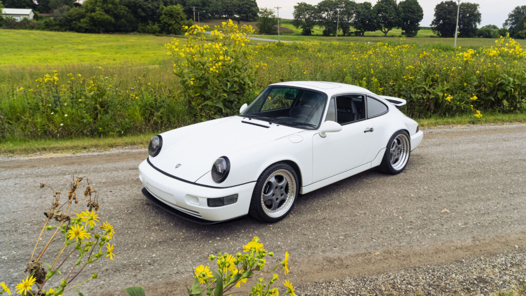 Classic white 1993 Porsche 964 sports car on rural road.