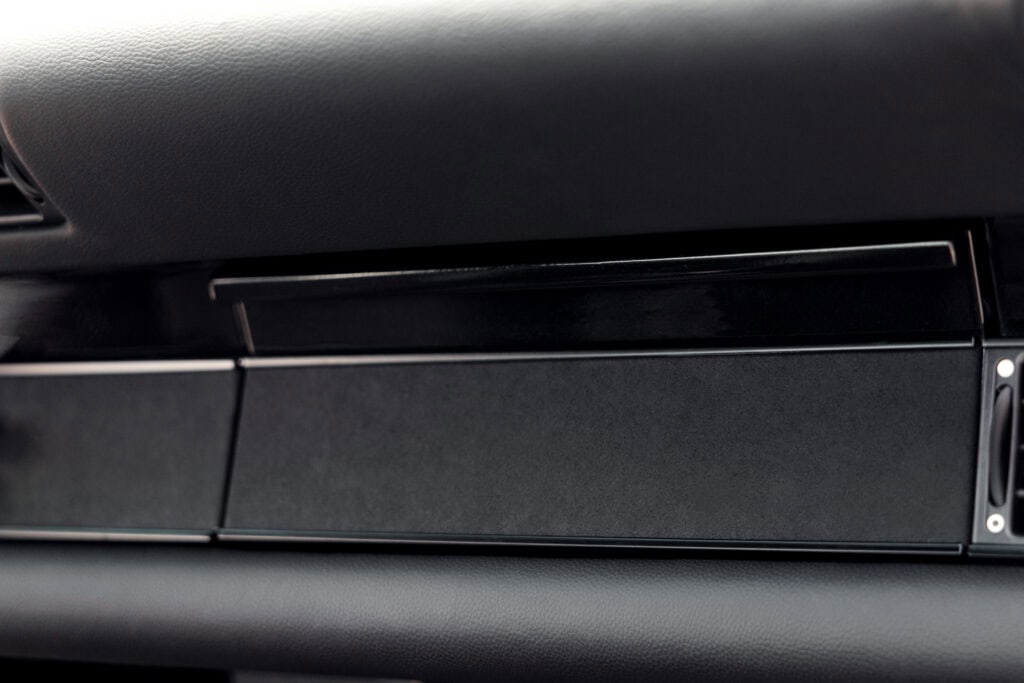 Close-up of the dashboard and glove compartment of a 1989 Porsche 964.