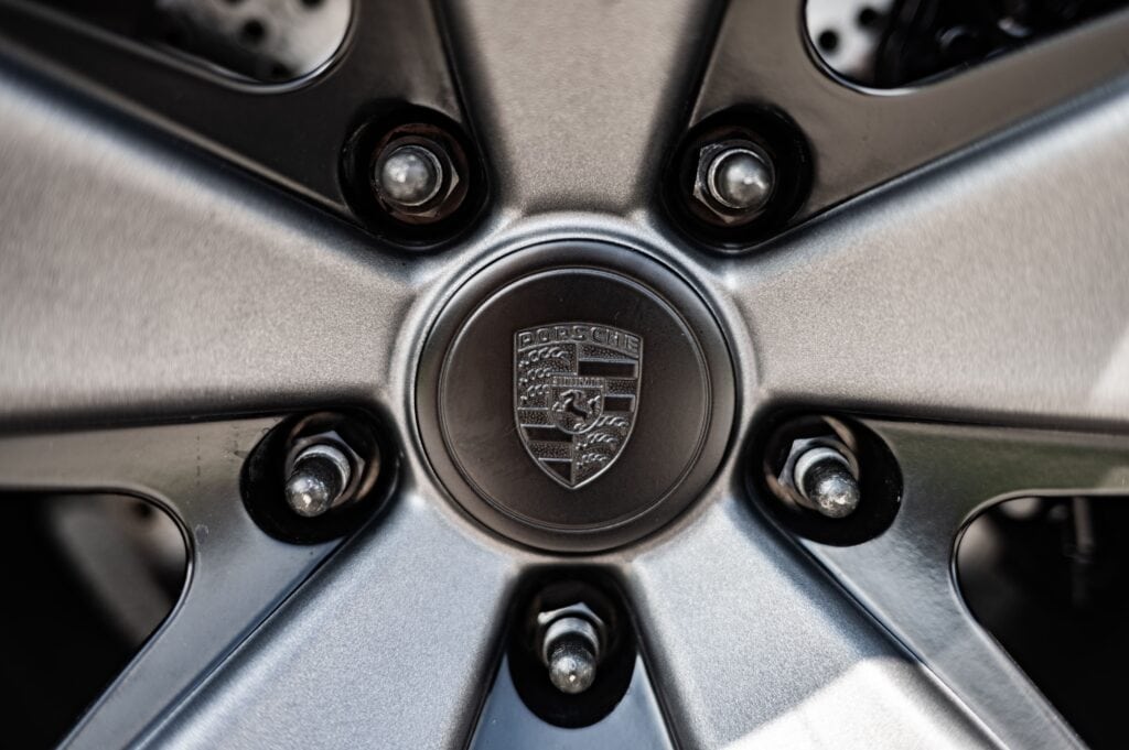 Close-up of Porsche 964 wheel center cap with logo.