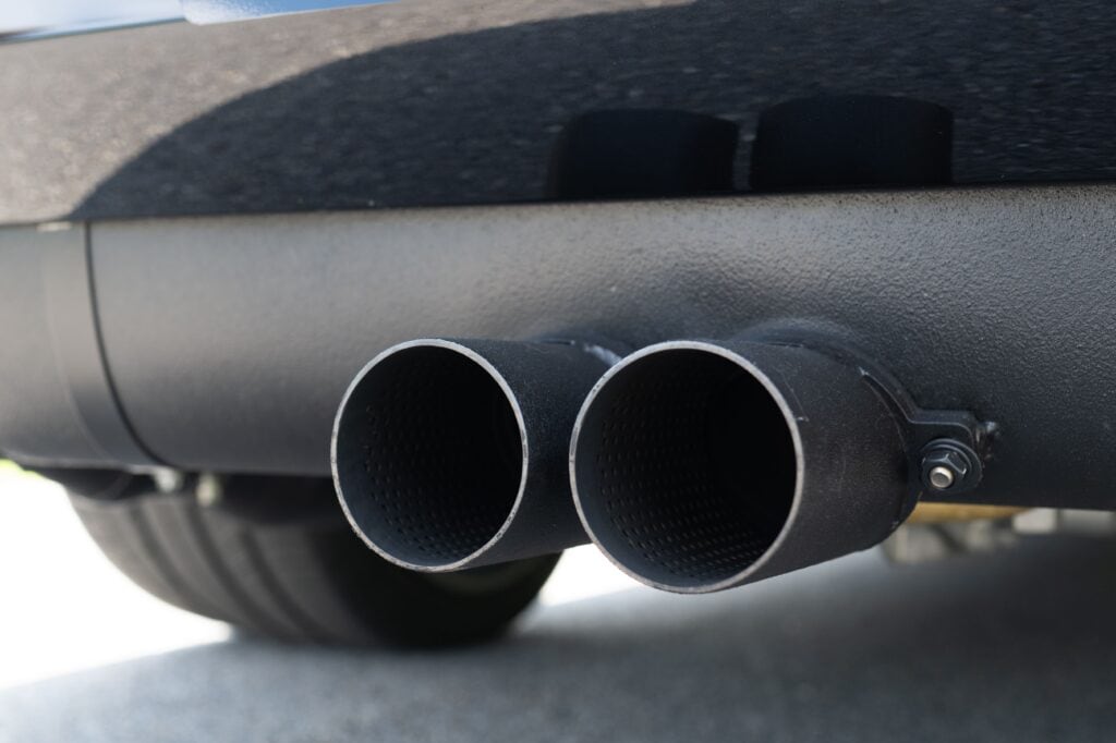 Close-up of dual exhaust pipes on a 1989 Porsche 964.