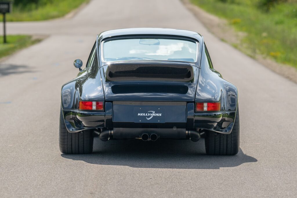 Classic 1989 Porsche 964 with black exterior on a rural road.