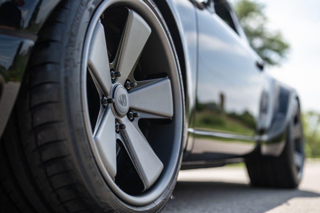 Close-up of a Porsche 964 wheel with five-spoke alloy rim and tire.